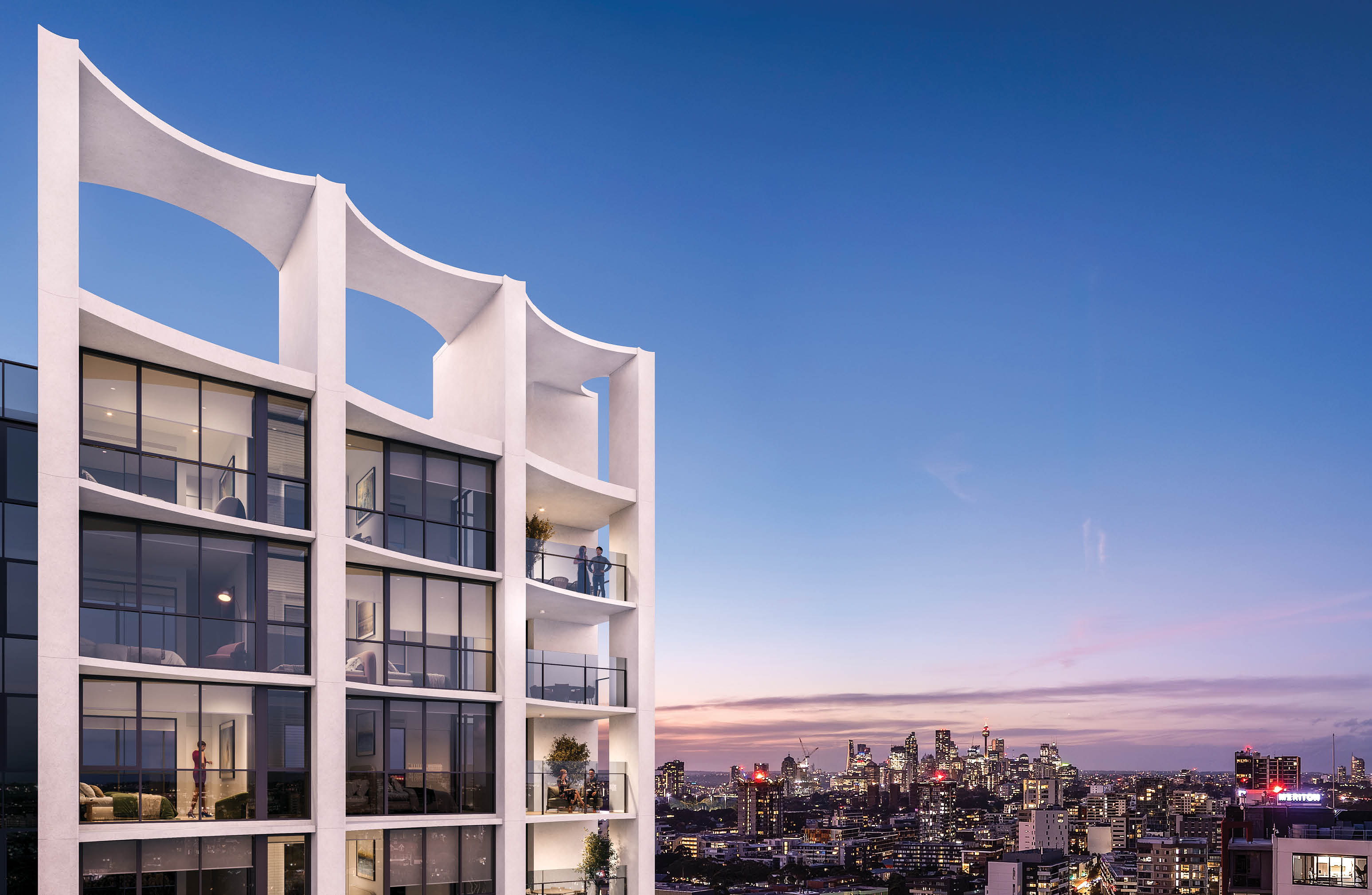 A modern white apartment building with large glass windows and balconies overlooks a city skyline at sunset with a clear blue and purple sky. Description generated by AI