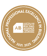 A circular gold emblem with white text reading National Professional Excellence in Building 2021, 2025 surrounding a white house-shaped logo with the letters AIB and the words Australian Institute of Building Advance Through Learning. Description generated by AI