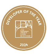 A gold circular badge with white text reading Developer of the Year 2024 and the Urban Development Institute of Australia New South Wales logo in the center. Description generated by AI