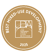 A gold circular badge with white text reading Best Mixed-Use Development 2025 surrounding the Urban Development Institute of Australia New South Wales logo. Description generated by AI