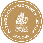 Gold circular emblem with a crest in the center and text indicating an award for the best mixed-use development in Australia for the years 2025 and 2026. Description generated by AI