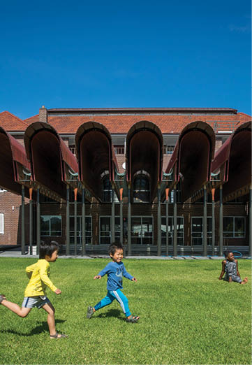 A group of children playing in a grassy field. Description generated by AI