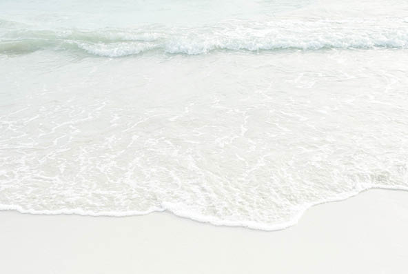 Soft wave of blue and green ocean/sea on sandy beach with bright sky on sunshine day. Background.