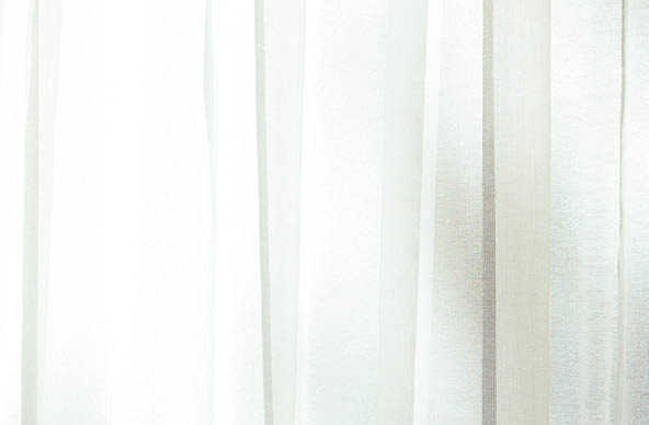 Background of net curtains with the sun shining through